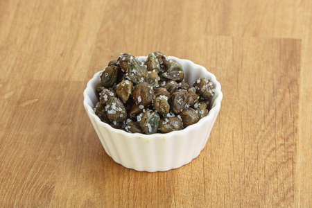 Salted marinated capers snack appetiser in the bowlの写真素材