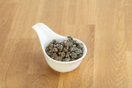Salted marinated capers snack appetiser in the bowlの写真素材