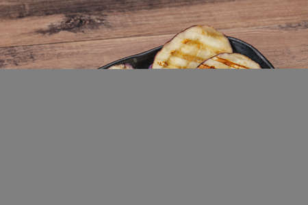 Grilled graffiti eggpant slices with olive oilの写真素材