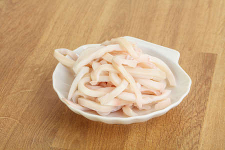 Marinated squid strips snack in the bowlの写真素材