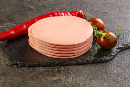 Sliced pork sausages stack over board for snack