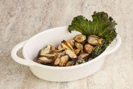 Tasty marinated mussels in the bowl with oilの写真素材