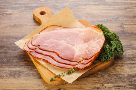 Tasty pork ham snack appetizer over boardの写真素材