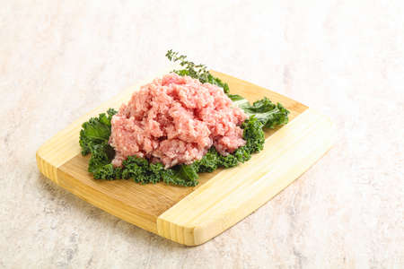 Raw pork homemade minced meat for cooking over boardの写真素材