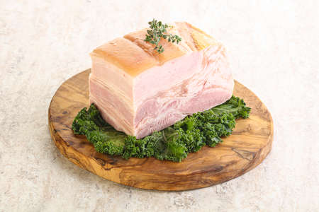 Cut of homemade pork bacon over boardの写真素材
