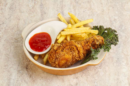 Crispy chicken leg with fry potato and sauceの写真素材