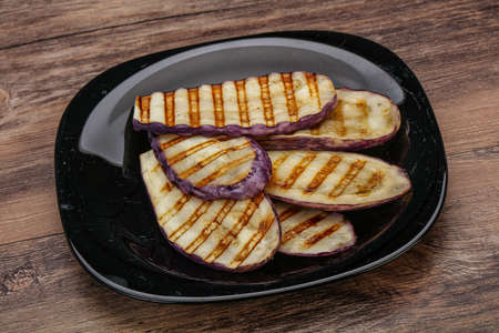 Grilled graffiti eggpant slices with olive oilの写真素材