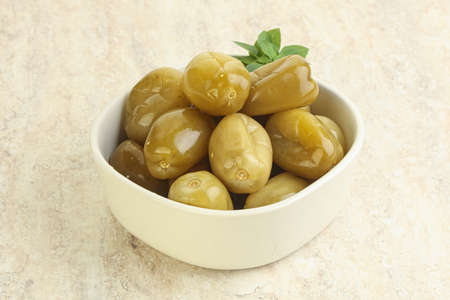 Pickled green tomato appetizer in the bowl