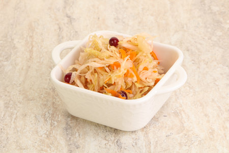 Fermented cabbage with carrot - sauerkraut in the bowlの写真素材