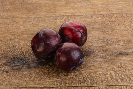 Ripe and sweet purple plum heap over backgroundの写真素材