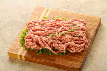 Raw minced pork meat over board for cooking