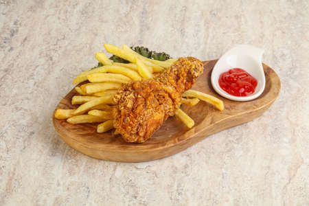 Crispy chicken leg with fry potato and sauceの写真素材