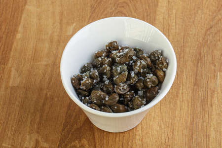 Salted marinated capers snack appetiser in the bowlの写真素材