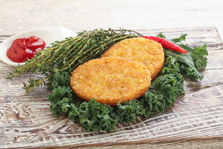 Fried crusty potato hashbrown pancake with sauceの写真素材