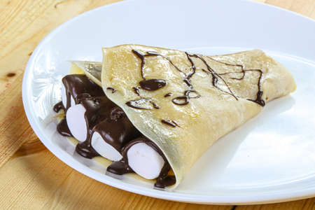 Pancake with marshmallow and liquid chocolateの写真素材
