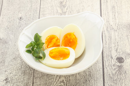 Boiled chicken egg for breakfast without eggshell in the bowlの写真素材