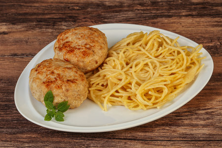 Spaghetti with cheese and homemade chicken cutletの写真素材