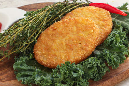 Fried crusty potato hashbrown pancake with sauce