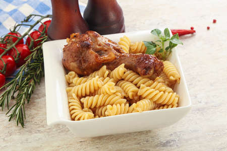 Roasted chicken leg with macaroni pastaの写真素材