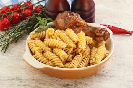 Roasted chicken leg with macaroni pastaの写真素材