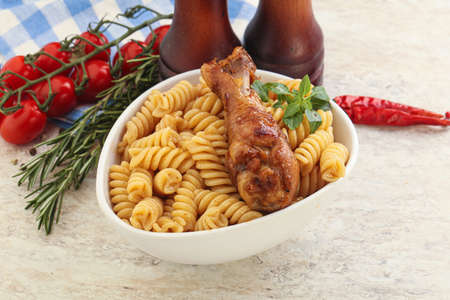Roasted chicken leg with macaroni pastaの写真素材