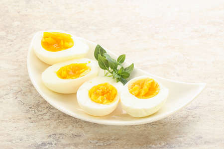 Boiled chicken egg for breakfast without eggshell in the bowlの写真素材