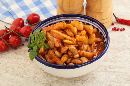 Roasted pork with white beans and tomato sauce