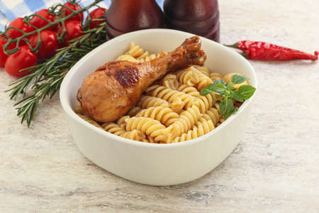 Roasted chicken leg with macaroni pastaの写真素材