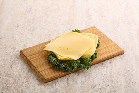 Sliced Gouda cheese snack over boardの写真素材