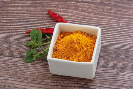 Yellow vibrant aroma curcuma powder in the bowl