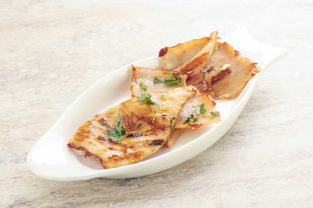 Grilled squid with unagi sauce and herbs