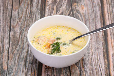 Salmon cream soup served dill in the bowlの写真素材