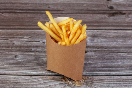 French fries potato fat and crispy over wooden background