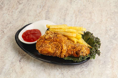 Crispy chicken leg with fry potato and sauceの写真素材