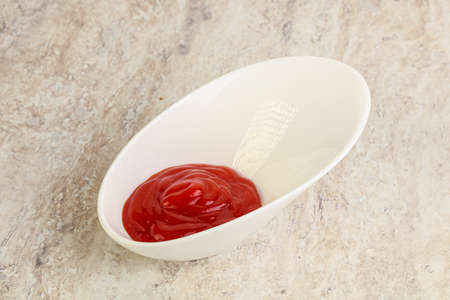 Hot and spicy Sriracha sauce in the bowlの写真素材