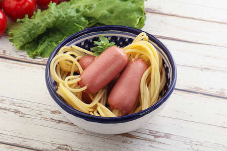 Mini sausages with pasta spaghetti for kidsの写真素材