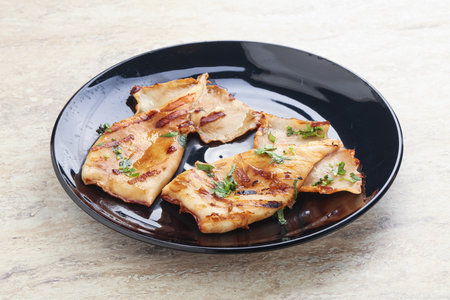 Grilled squid with unagi sauce and herbs