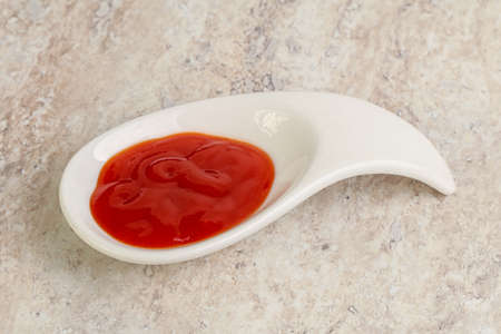 Hot and spicy Sriracha sauce in the bowlの写真素材