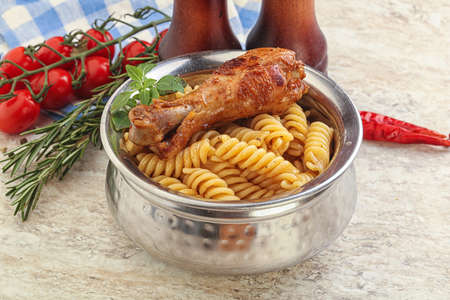 Roasted chicken leg with macaroni pastaの写真素材
