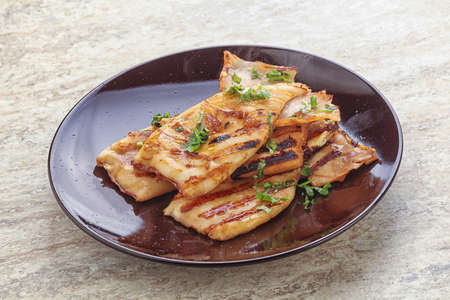 Grilled squid with unagi sauce and herbs