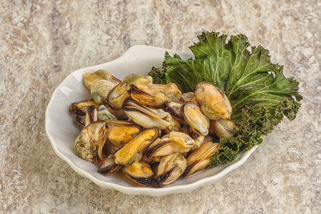 Tasty marinated mussels in the bowl with oilの写真素材