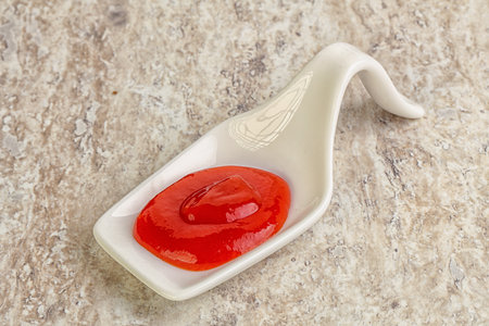 Hot and spicy Sriracha sauce in the bowlの写真素材