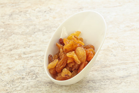 Sweet tasty yellow raisin in the bowlの写真素材