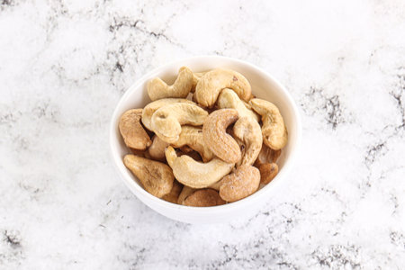 Cashew nuts heap in the bowl for snackの写真素材