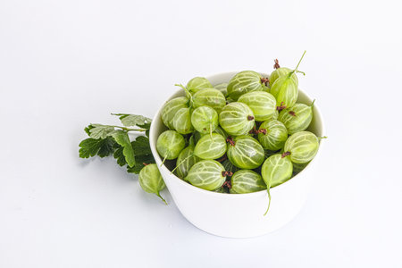 Sweet ripe green gooseberries in the bowlの写真素材