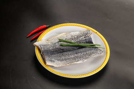 Herring pickled fillet with skin served green onion