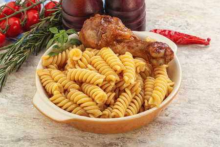 Roasted chicken leg with macaroni pastaの写真素材