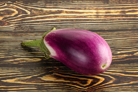 Raw purple ripe eggplant for cooking over backgroundの写真素材