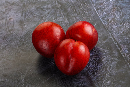 Ripe sweet juicy red plum heapの写真素材