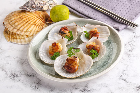 Grilled scallops shell with butter and parsleyの写真素材